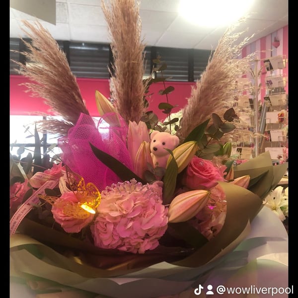 Soft pastel flower arrangement in peach and blush tones