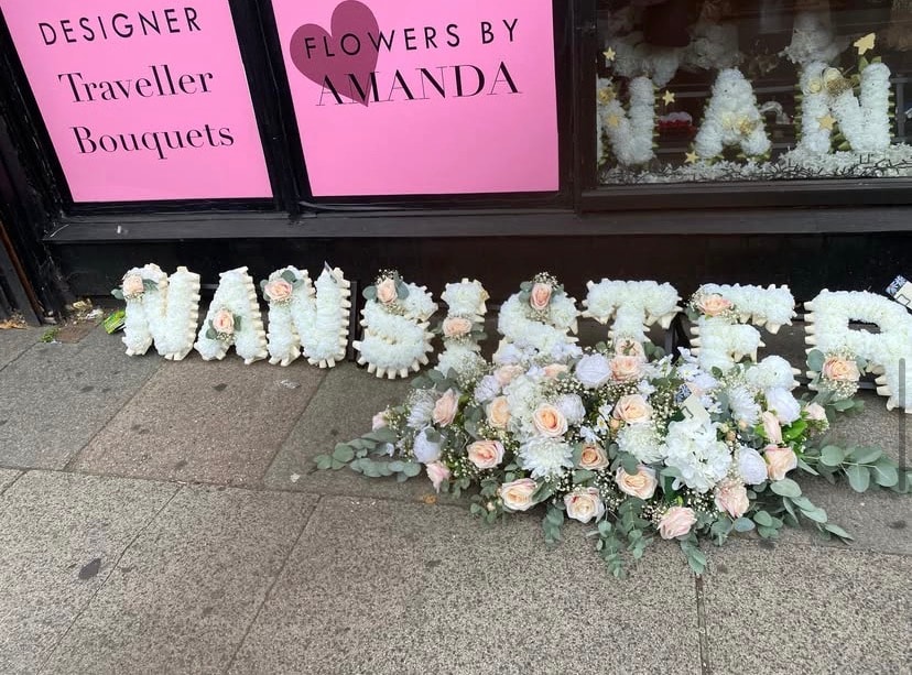 Floral tribute display outside flower shop