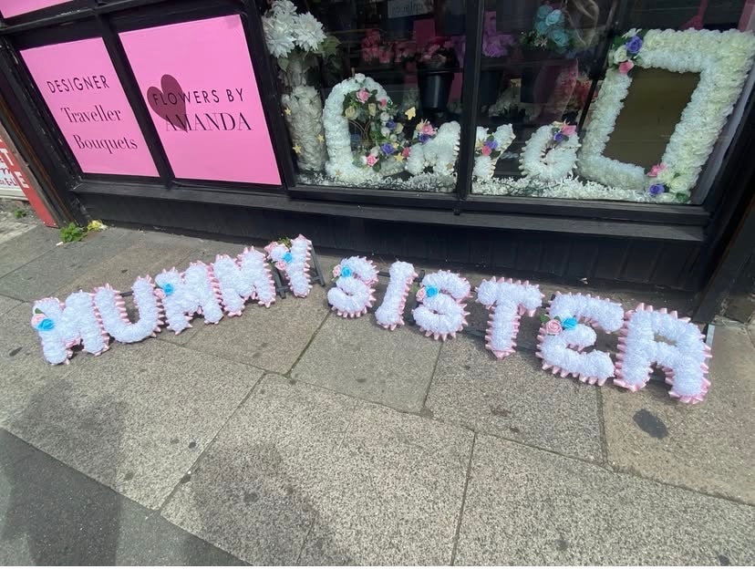 Floral tribute outside flower shop